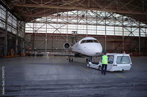Business jet airplane stays in hangar.