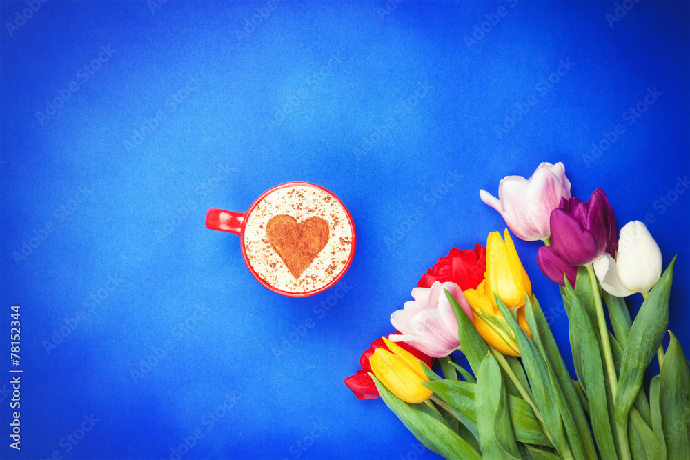 Cup near flowers on blue background - obrazy, fototapety, plakaty 