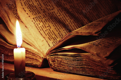 concept of knowledge, vintage book candle photo