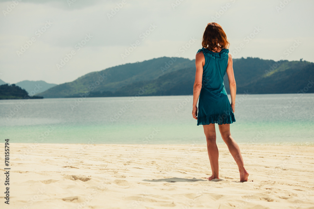 Young woman walking on tropical beach