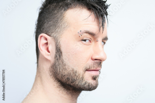 A sexy portrait of a man over a gray background