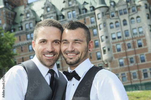 Portrait of a loving gay male couple on their wedding day. photo