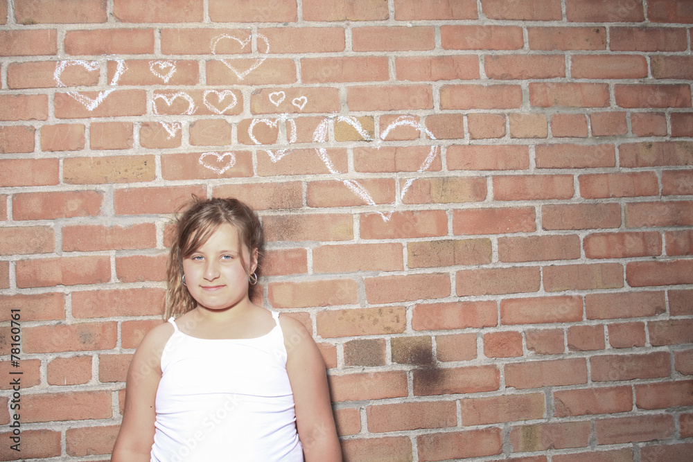 A child with brink wall as a background A child with brink wall as a background