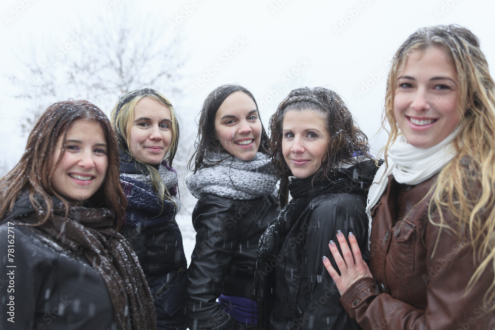 Fototapeta premium A Group of excited young girl friends outdoors in winter