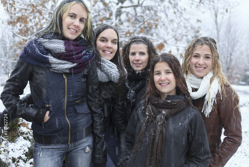 A Group of excited young girl friends outdoors in winter
