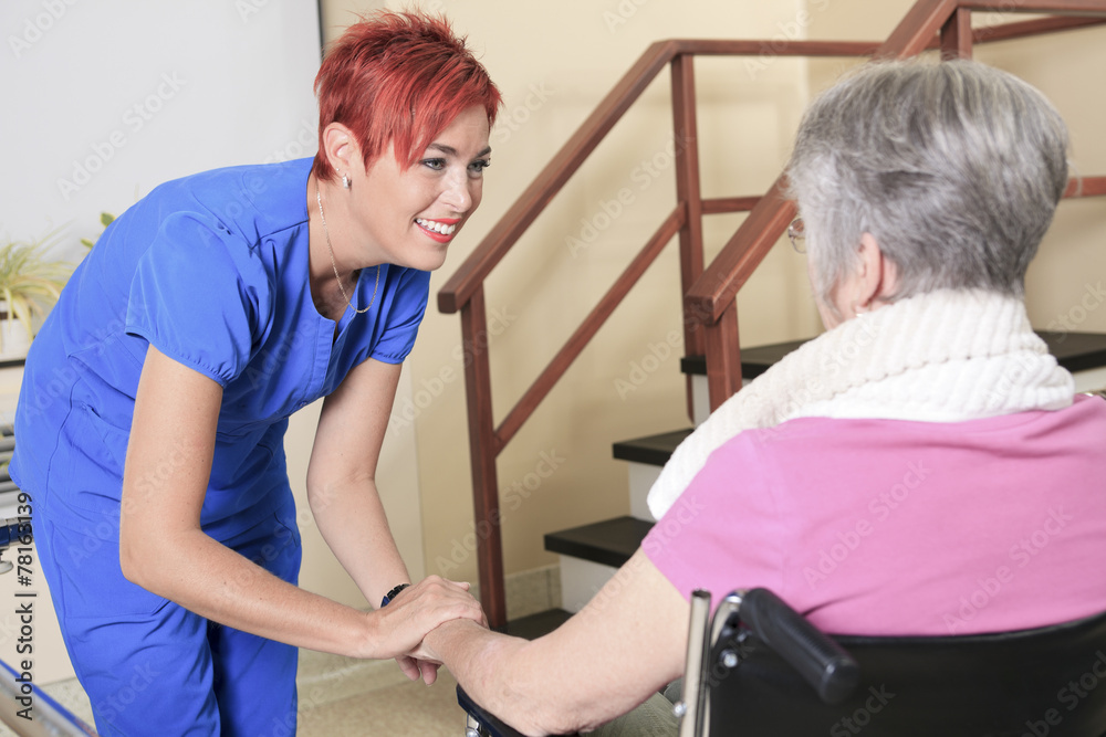 Elderly lady with her physiotherapists in a hospital Elderly lady with her physiotherapists in a hospital
