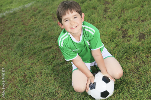Kid play soccer on a field