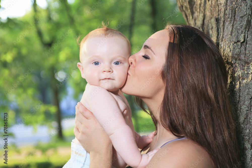 A mother with is baby on a beautiful forest A mother with is baby on a beautiful forest