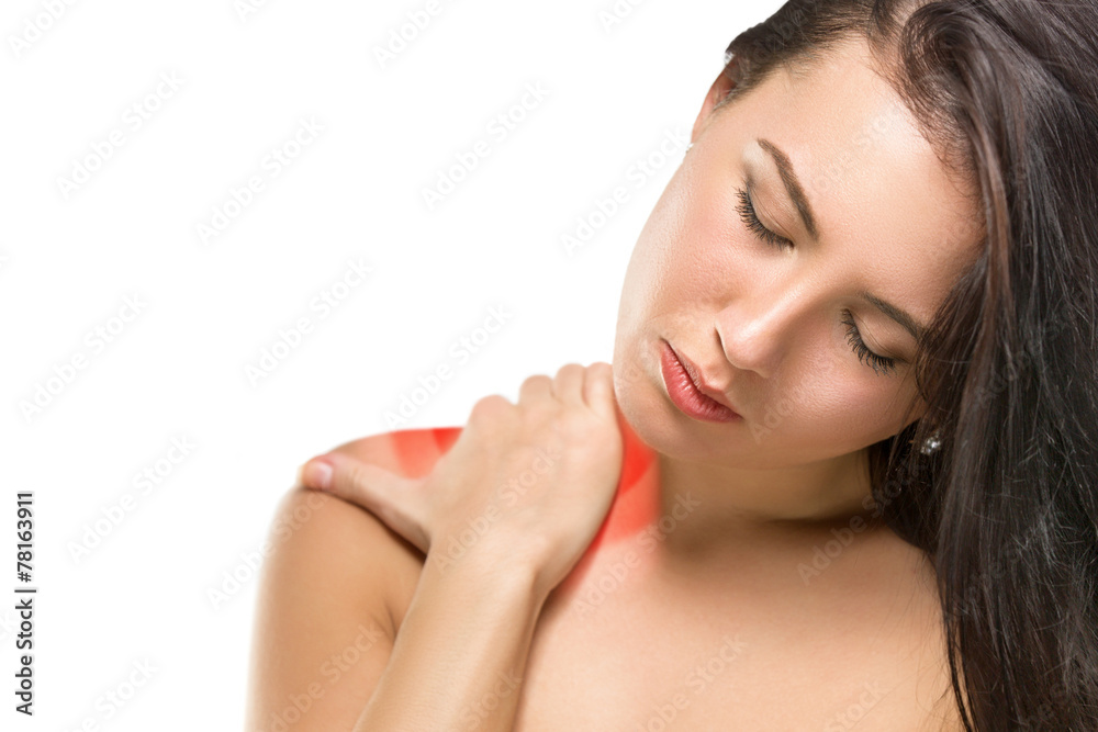 Brunette woman massaging her shoulder Brunette woman massaging her shoulder