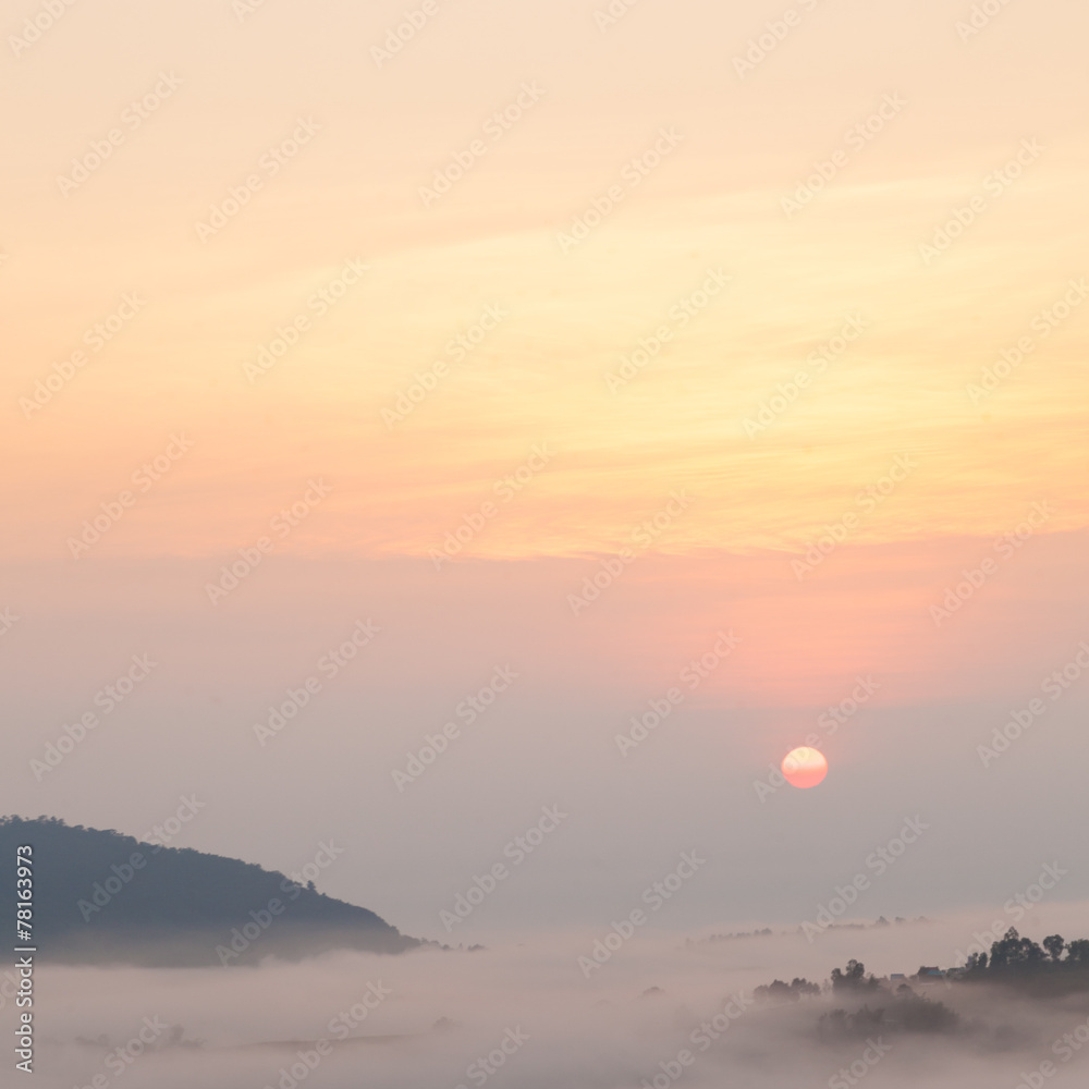 sunrise and mist-covered mountains