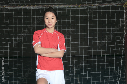 A female soccer player in a stadium photo