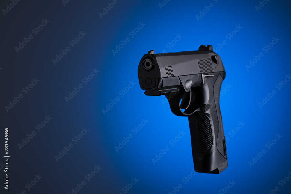 Handgun with blue and black background