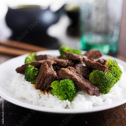 chinese beef and broccoli stir fry on rice photo