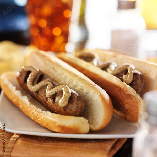 bratwursts in hot dog buns with gourmet mustard photo