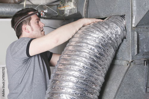 A ventilation cleaner man at work with tool photo