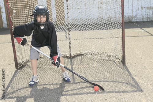 A Portrait of hockey ball player with hockey stick photo