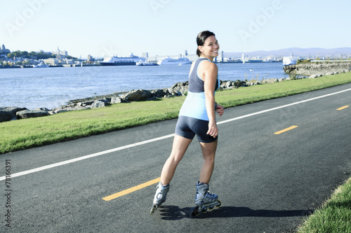 A woman with is rollerblade in summer time