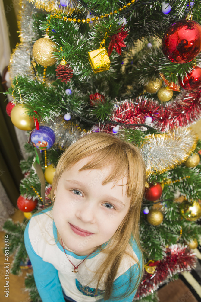 Portrait of a smiling girl on the background of Christmas trees