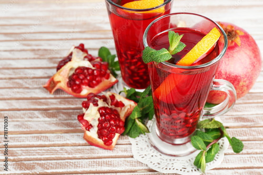 Pomegranate drink in glasses with mint and slices of orange Pomegranate drink in glasses with mint and slices of orange
