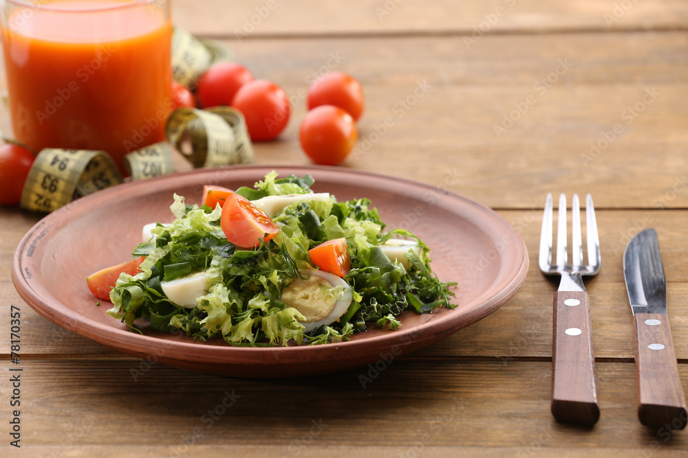 Salad with quail egg and basil in plate