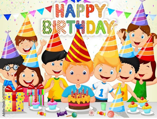 Happy boy blowing birthday candles with his friends