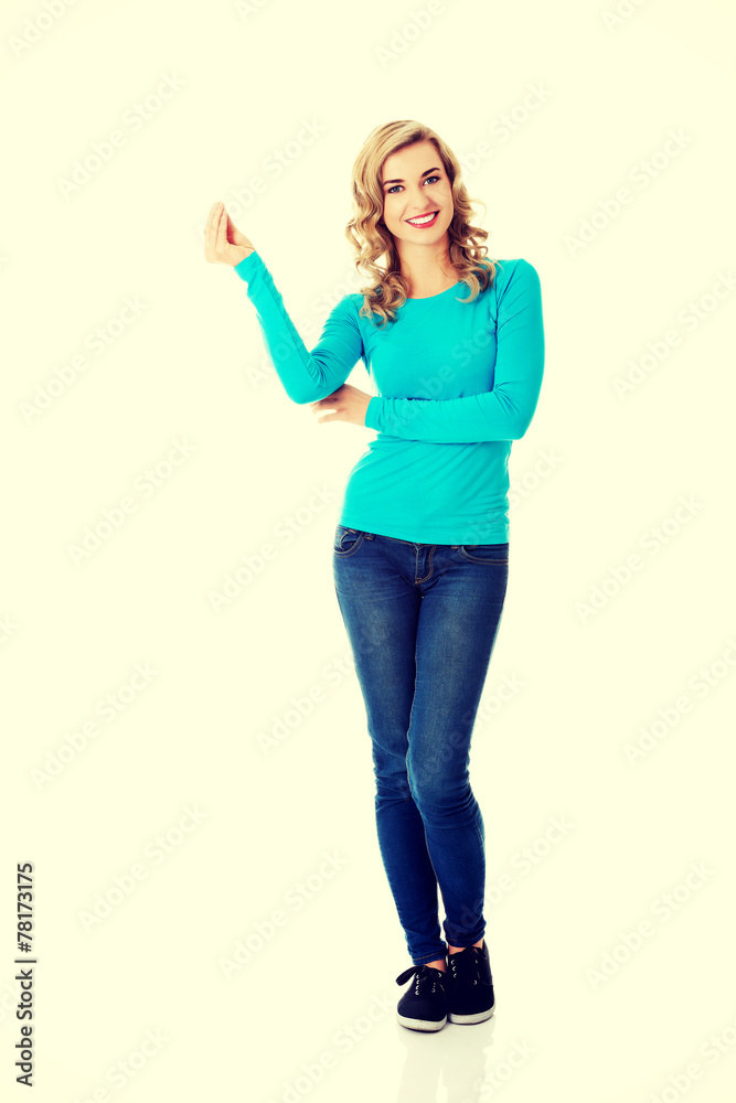 Casual woman presenting a copyspace. Casual woman presenting a copyspace.