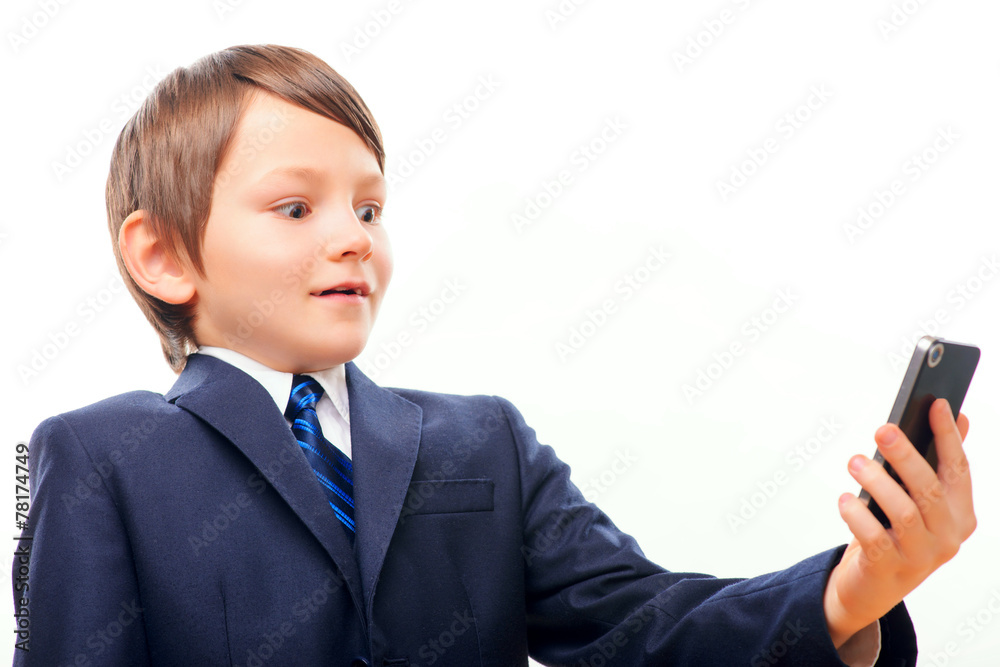 Business child in suit and tie posing with cell phone
