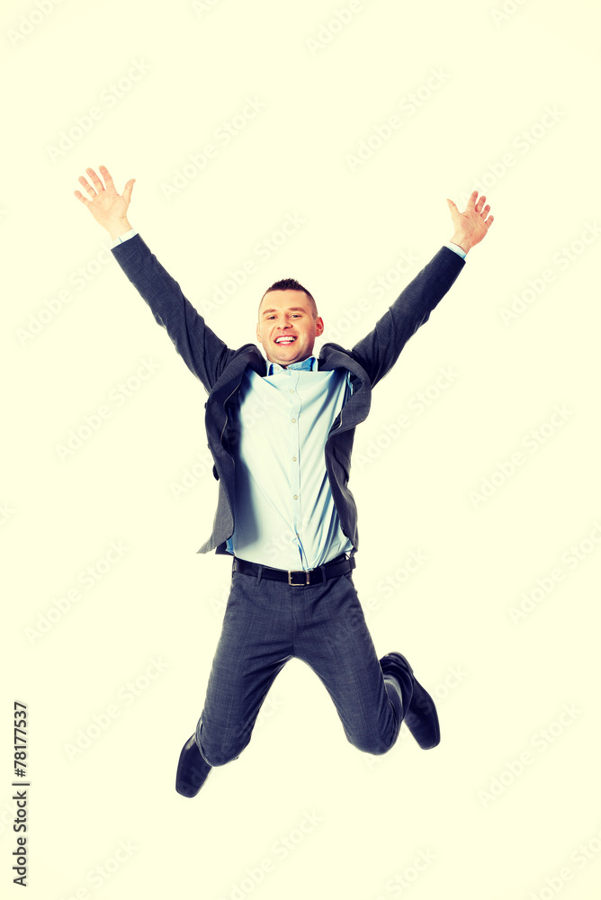 Happy businessman jumping