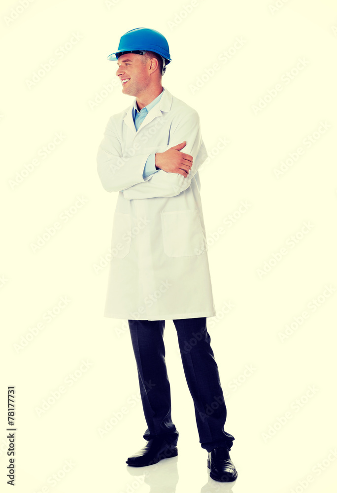 Man in a lab coat and helmet Man in a lab coat and helmet
