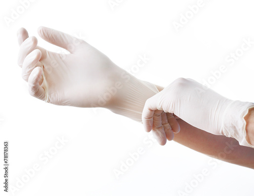 Obraz na plátně Doctor putting on sterile gloves isolated on white