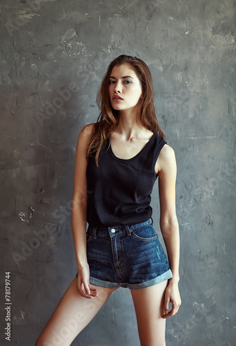 fashion young woman on grunge wall background