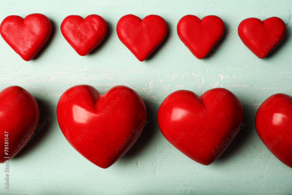 Fototapeta premium Decorative hearts on wooden background