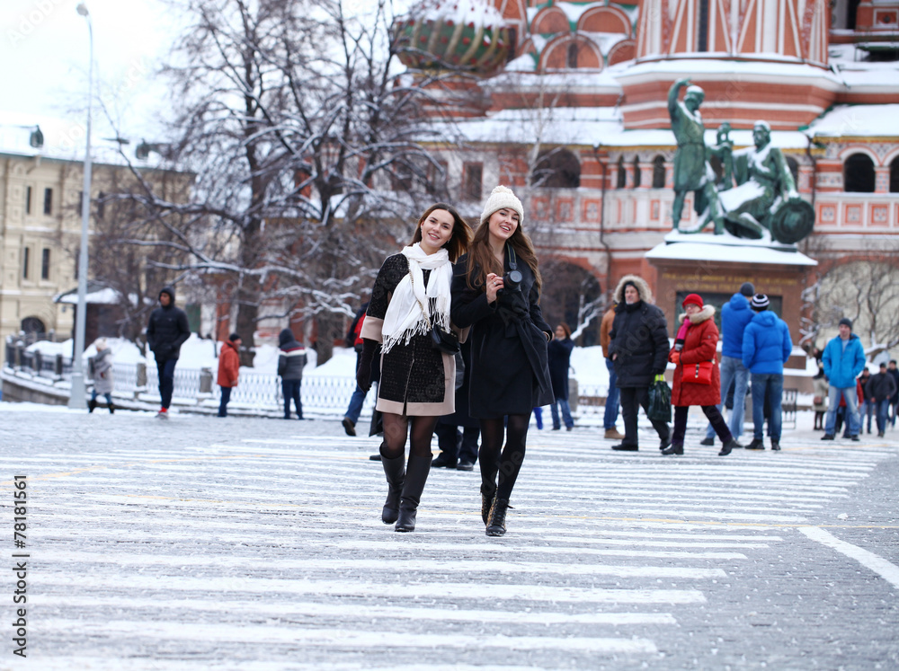 Two girls tourists are photographed in Moscow (Russia)