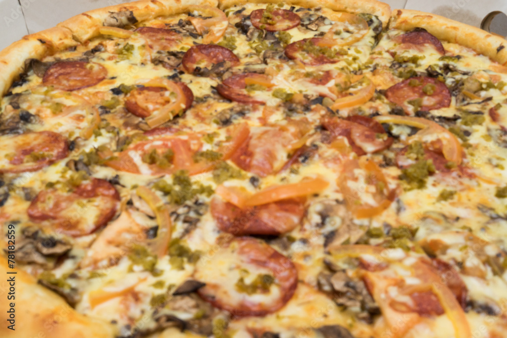 pizza with sausages, tomatoes and spinach close up view pizza with sausages, tomatoes and spinach close up view