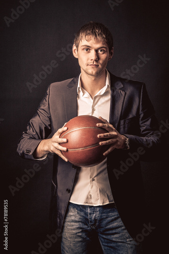 Young man holding basketball ball © Fxquadro