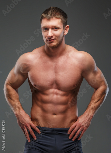 Big brutal musculed man showing his body