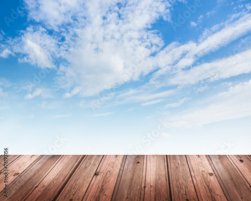 Background with blue sky and wooden table