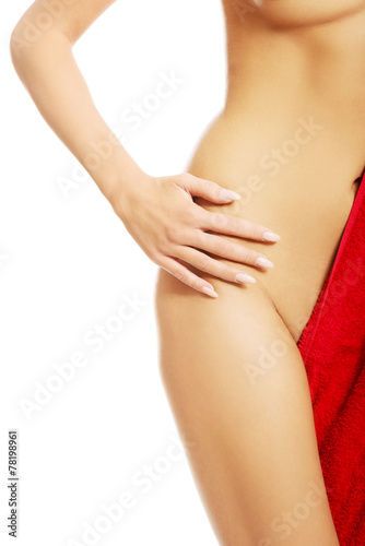 Slim nude woman touching her hip © Piotr Marcinski