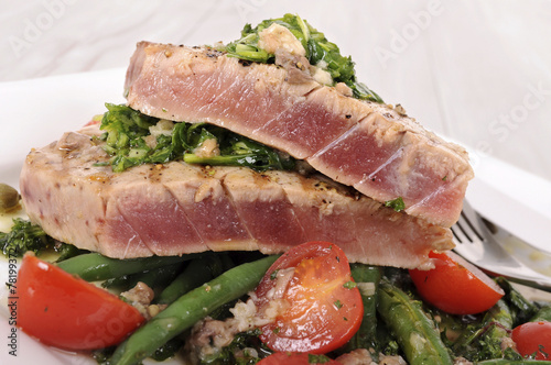 Seared tuna steak with bean and tomato salad