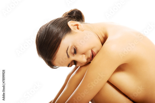 Spa woman sitting with head on knees