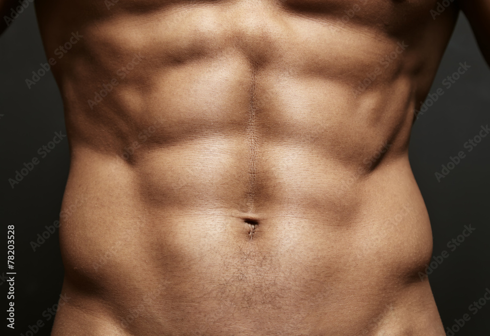 Closeup photo of an athlete with perfect abs - obrazy, fototapety, plakaty 