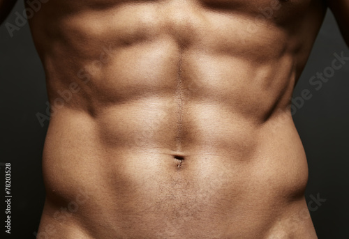 Closeup photo of an athlete with perfect abs