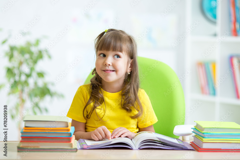 smiling child girl reading book at home smiling child girl reading book at home