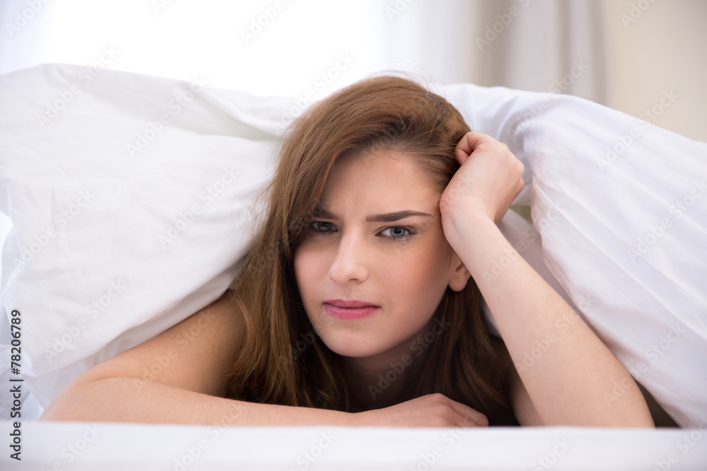 Beautiful young woman under the blanket in the bed Beautiful young woman under the blanket in the bed