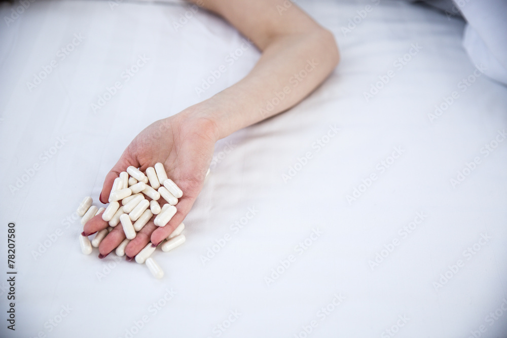 Obraz premium Closeup image of a female hand holding pills