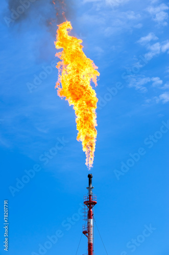 Gas flaring. Torch against the sky.