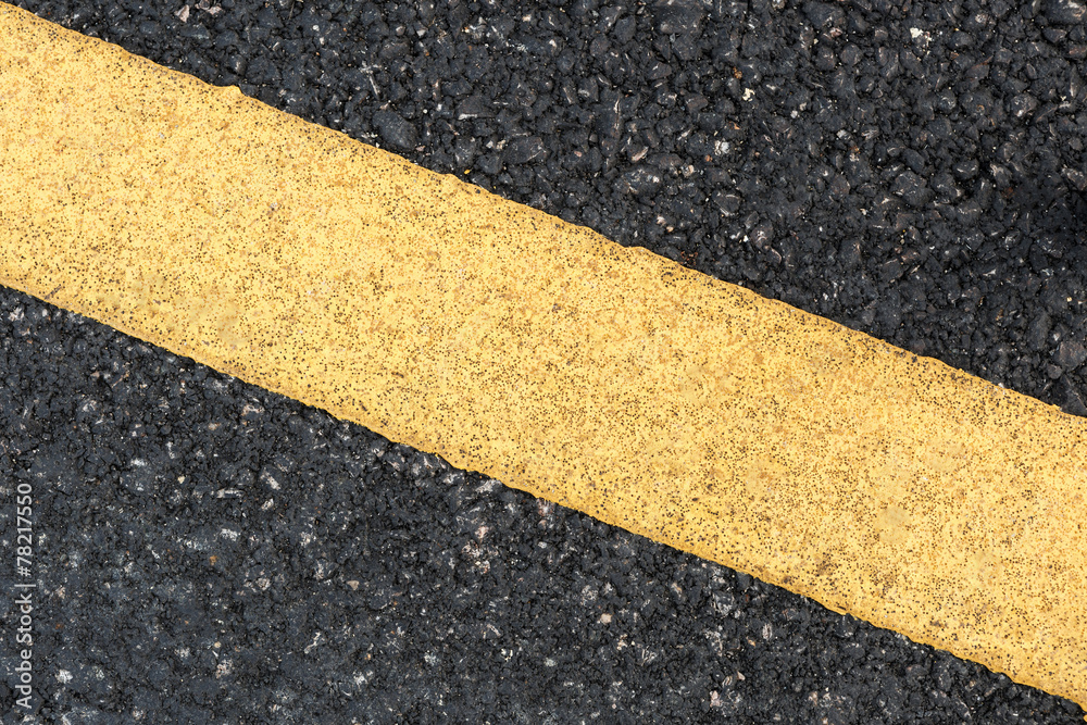 Fototapeta premium Yellow line on road texture