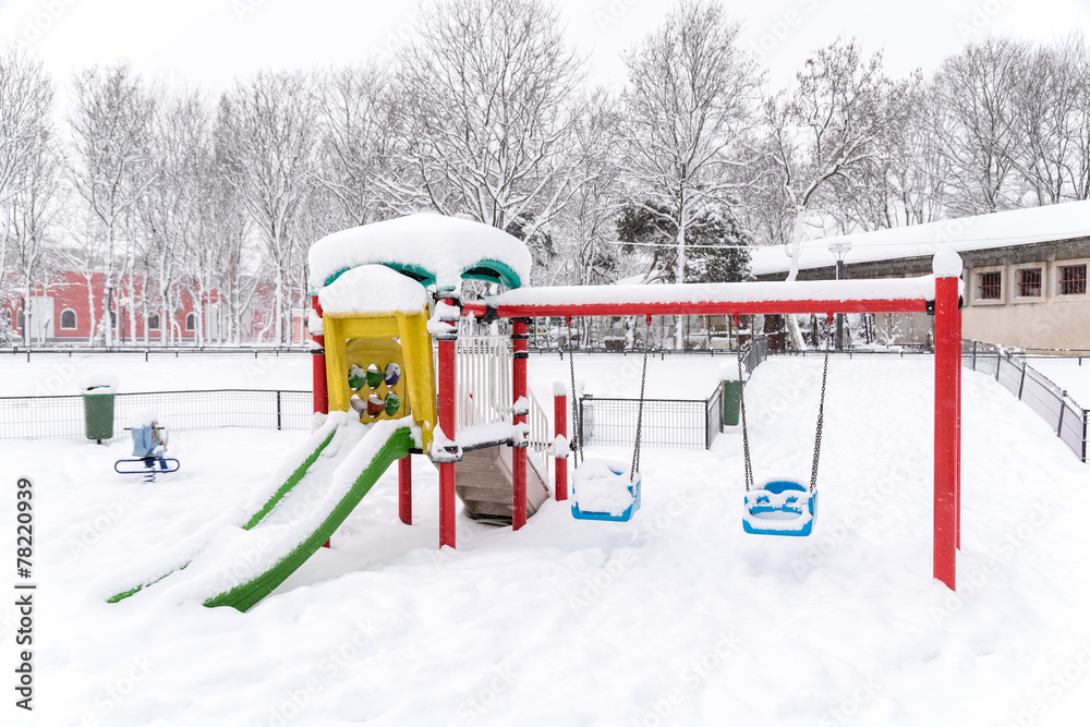 Children Playground In Public Park Covered With Winter Snow Children Playground In Public Park Covered With Winter Snow