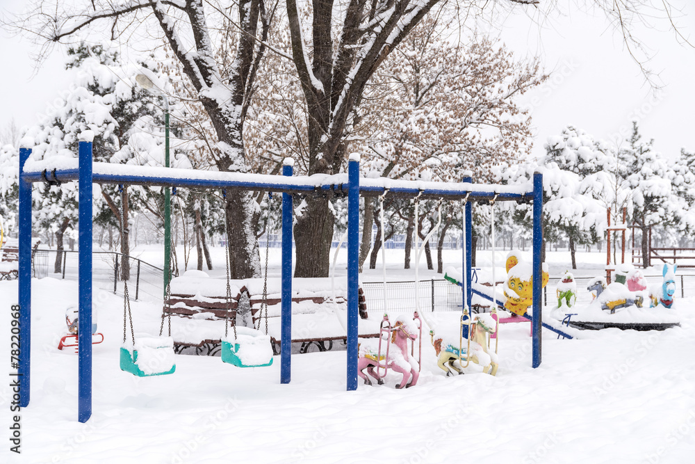 Children Playground In Public Park Covered With Winter Snow Children Playground In Public Park Covered With Winter Snow