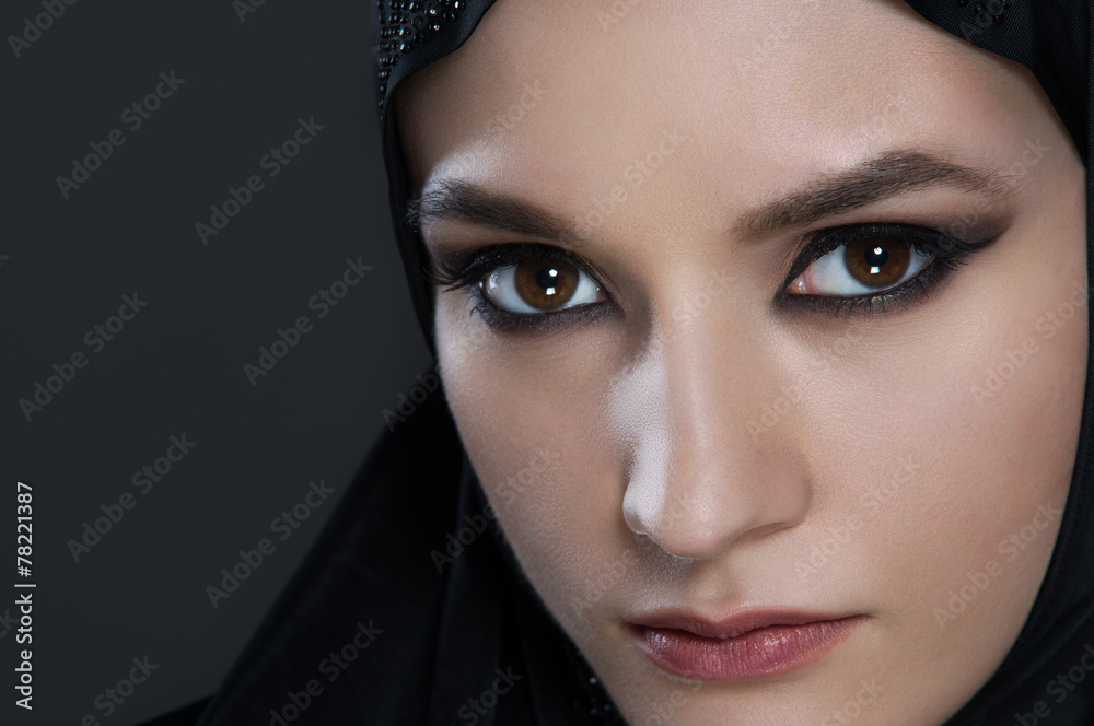 arabian woman with black vell on black background